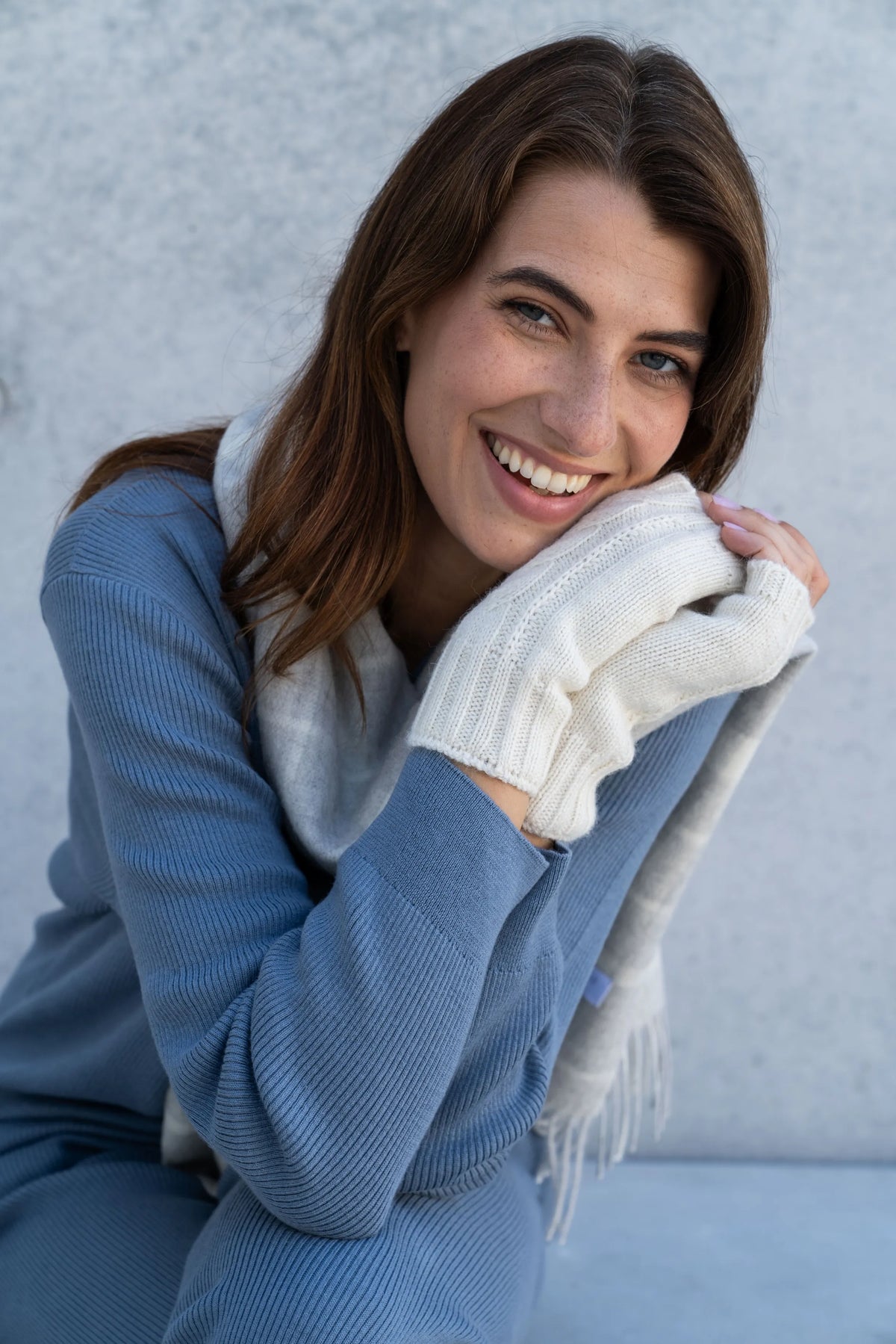 The Alpaca Scarf & Wristwarmer Gift: grey plaid alpaca scarf and white cable-knit wristwarmers worn together